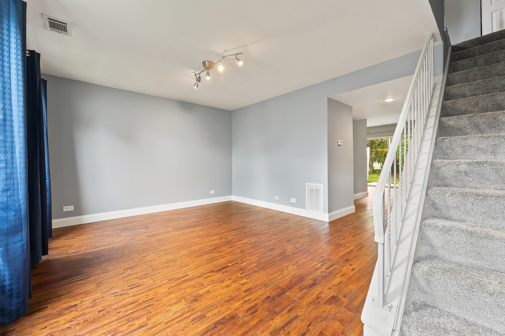 362 Rodenburg Road Roselle, IL 60172 - Photo 6 of 19 a view of an empty room with wooden floor and a window