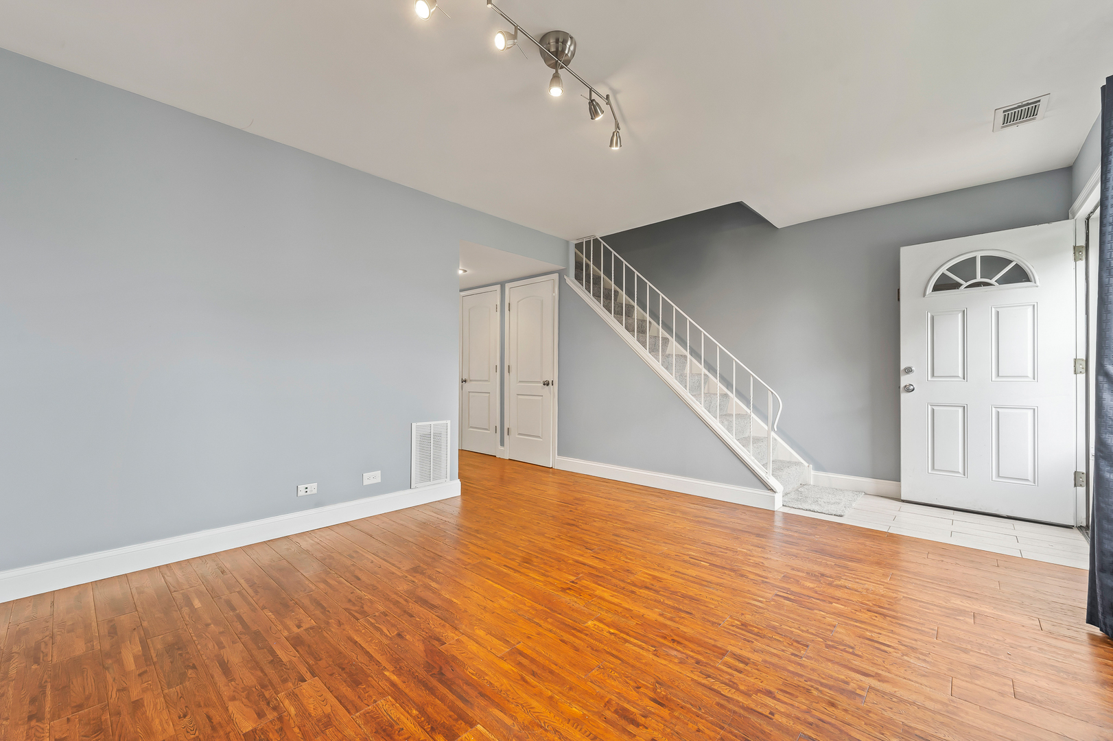 362 Rodenburg Road Roselle, IL 60172 - Photo 7 of 19 a view of an empty room with wooden floor and stairs
