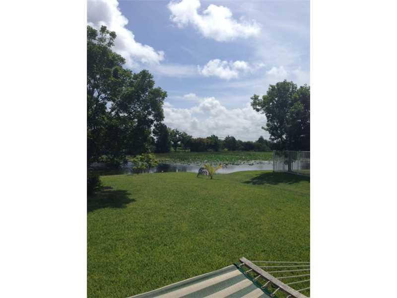 949 Falling Water Road Weston, FL 33326 - Photo 11 of 12 a view of a golf course with a lake view