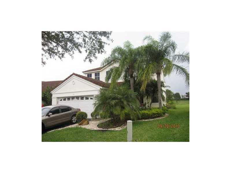949 Falling Water Road Weston, FL 33326 - Photo 3 of 12 a view of a yard in front of a house