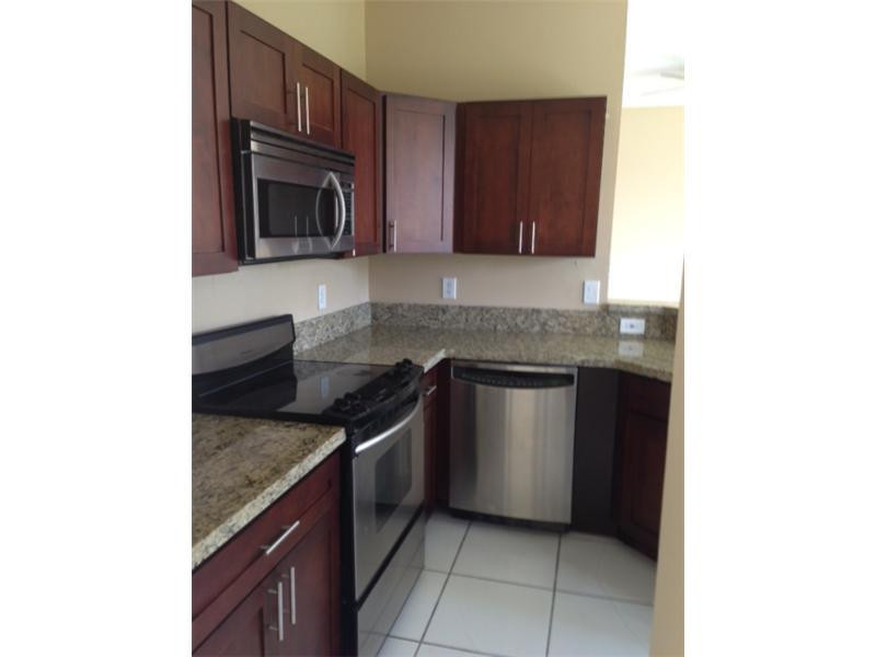 949 Falling Water Road Weston, FL 33326 - Photo 5 of 12 a kitchen with granite countertop a sink and a stove