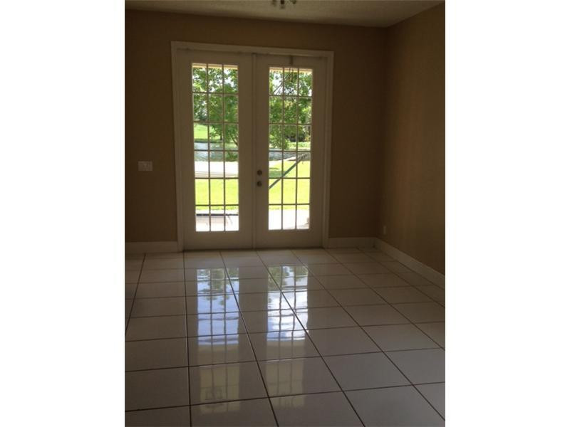 949 Falling Water Road Weston, FL 33326 - Photo 6 of 12 a view of an empty room with windows