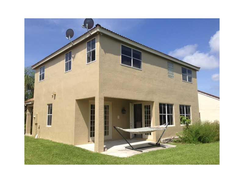 949 Falling Water Road Weston, FL 33326 - Photo 9 of 12 a front view of a house with garden