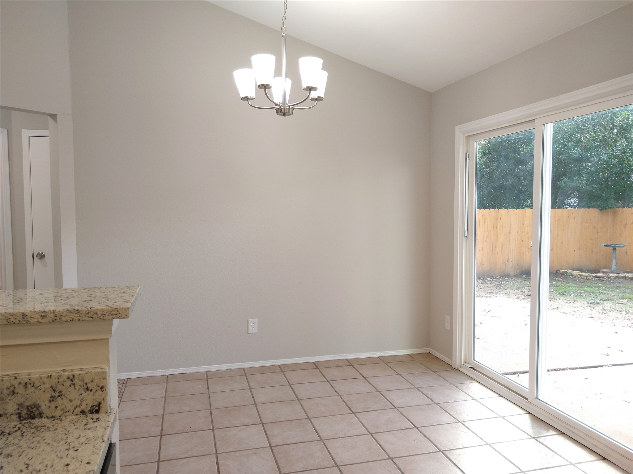 1813 Laurel Path Round Rock, TX 78664 - Photo 12 of 35 Granite counters complement the dining space, featuring sliding glass doors to the backyard.