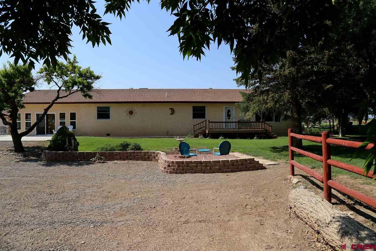 3946 1550 Road Delta, CO 81416 - Photo 2 of 35 a front view of a house with a garden