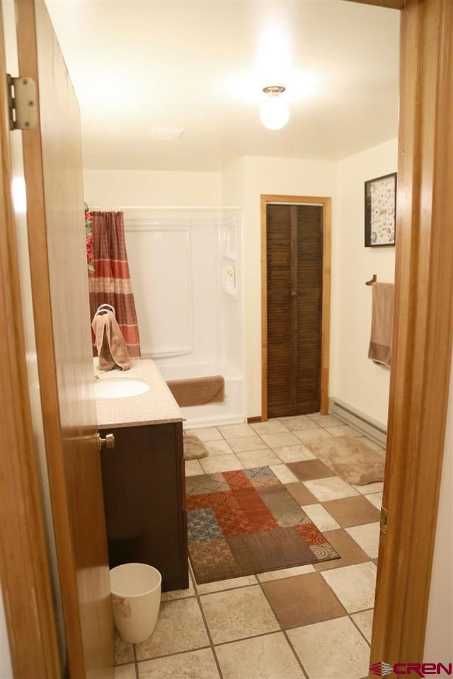 3946 1550 Road Delta, CO 81416 - Photo 13 of 35 a bathroom with a sink and a toilet