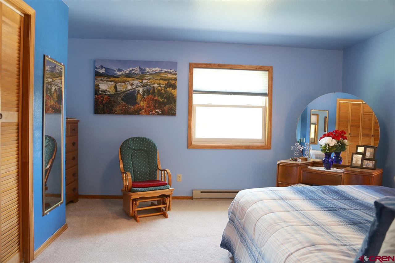 3946 1550 Road Delta, CO 81416 - Photo 14 of 35 a bedroom with a bed and window