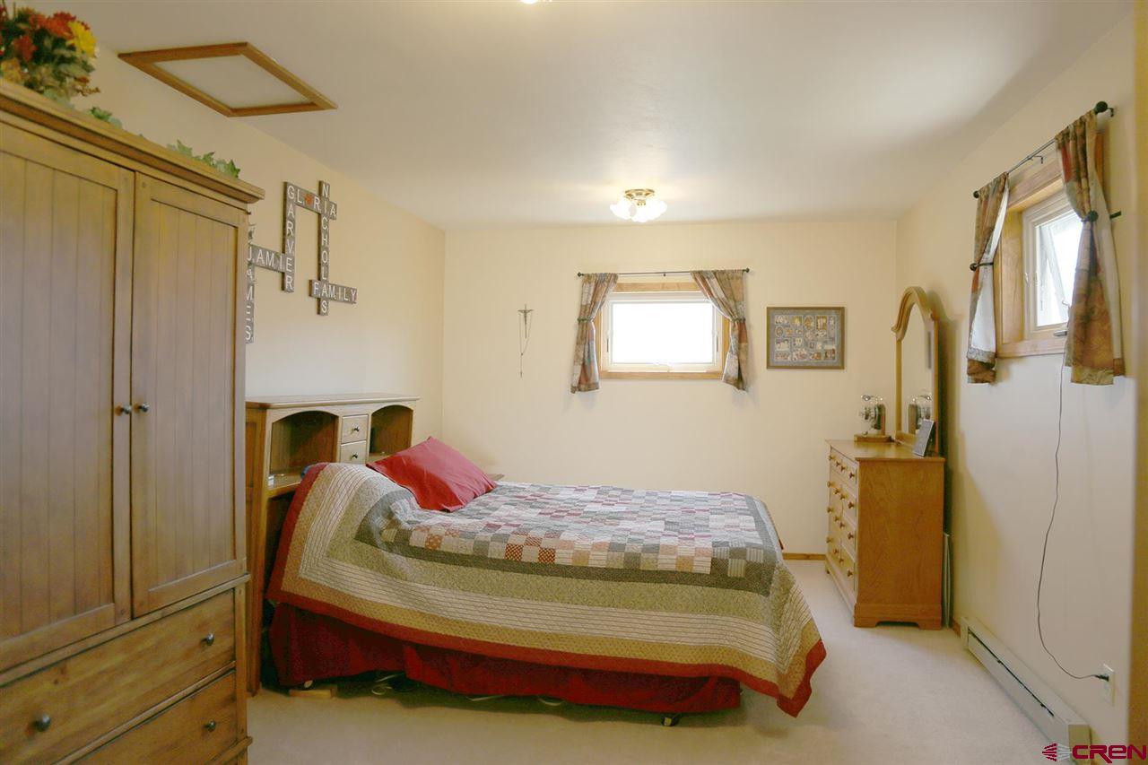 3946 1550 Road Delta, CO 81416 - Photo 15 of 35 a bedroom with a bed dresser and a window