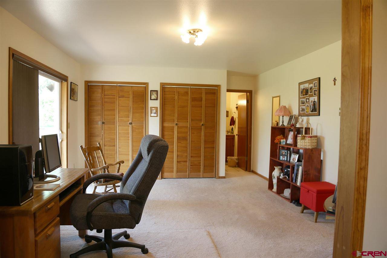 3946 1550 Road Delta, CO 81416 - Photo 16 of 35 a view of a livingroom with furniture and windows