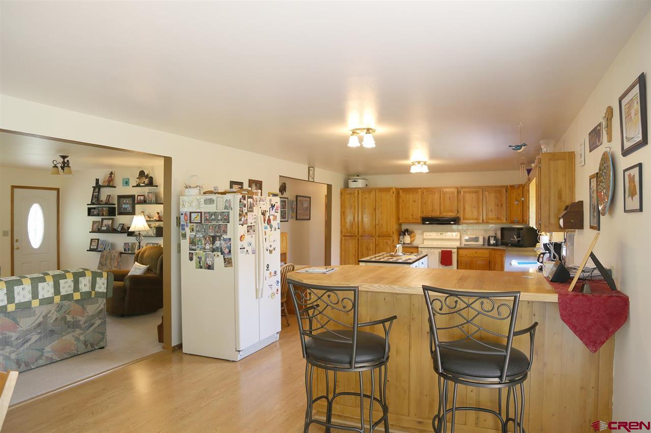 3946 1550 Road Delta, CO 81416 - Photo 8 of 35 a kitchen with refrigerator and cabinets