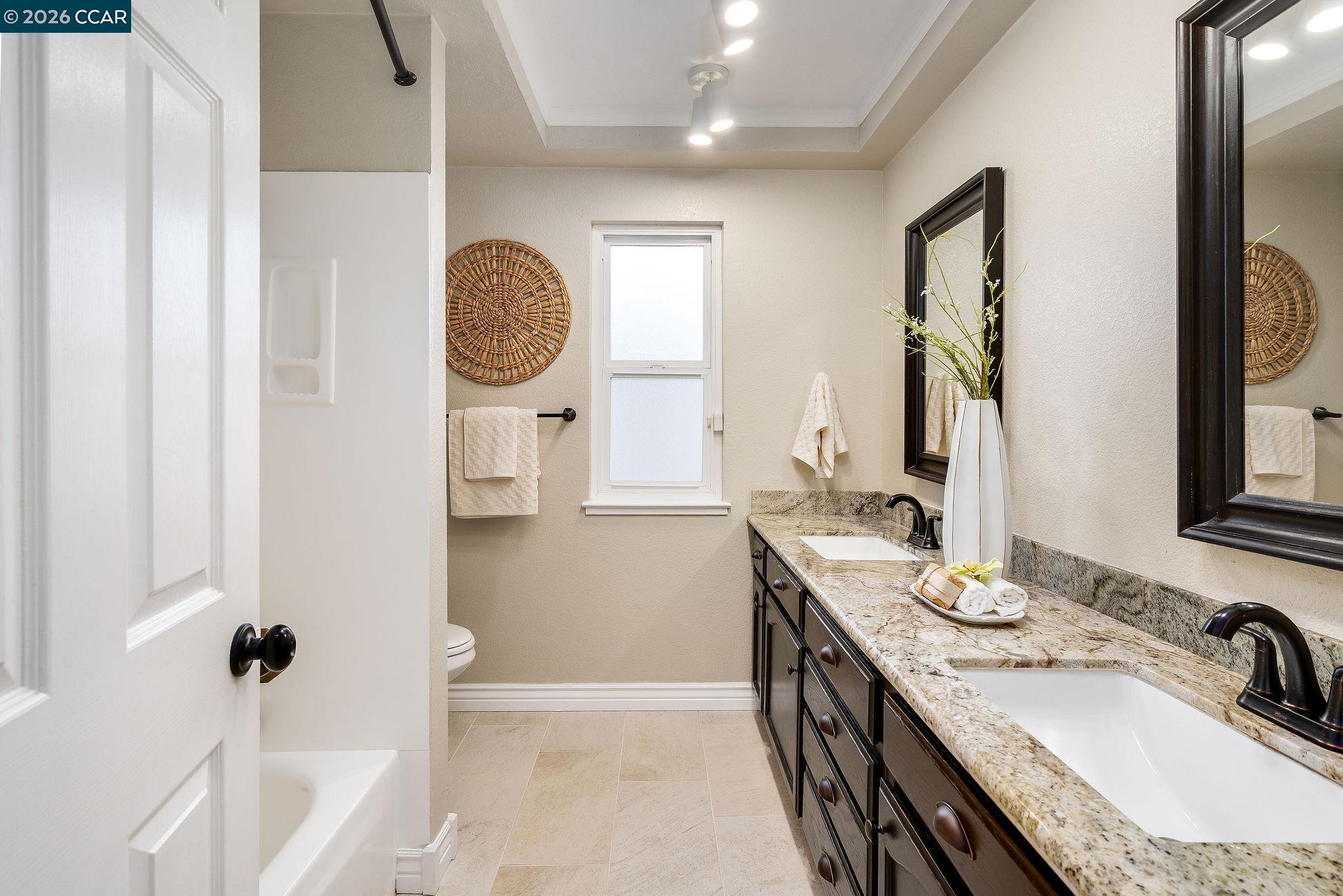 633 Lomond Circle San Ramon, CA 94583 - Photo 30 of 39 a bathroom with a granite countertop sink mirror and vanity