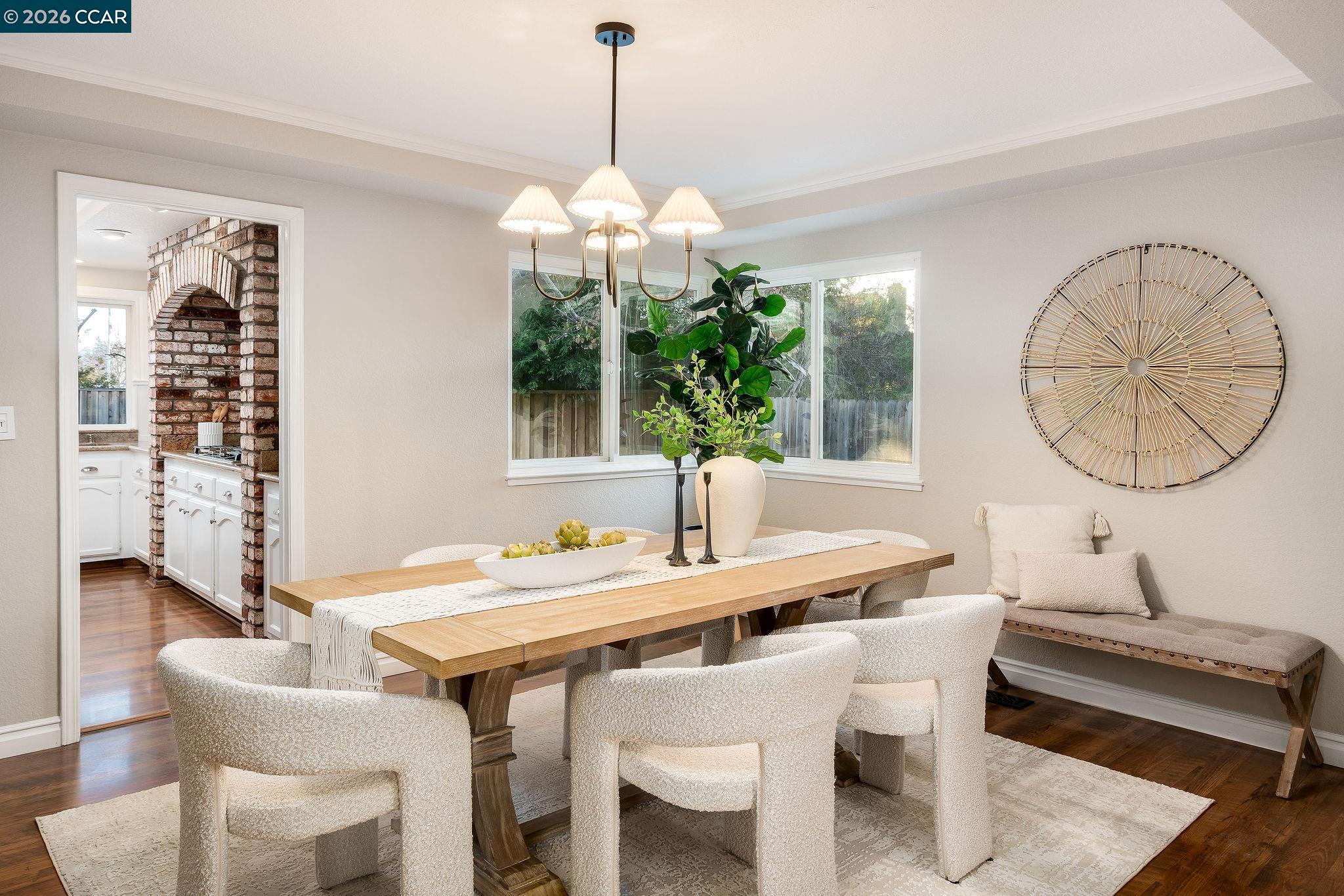 633 Lomond Circle San Ramon, CA 94583 - Photo 8 of 39 a dining room with wooden floor a chandelier a wooden table and chairs