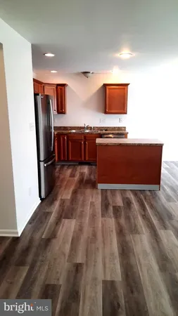 a view of kitchen with stainless steel appliances granite countertop cabinets and a counter top space