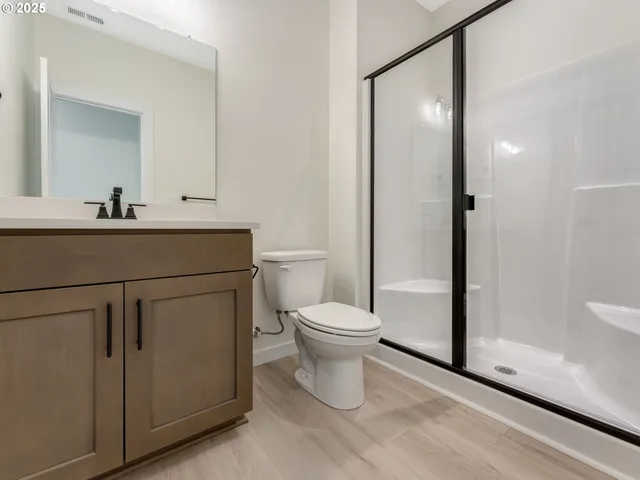 a bathroom with a toilet a sink and shower