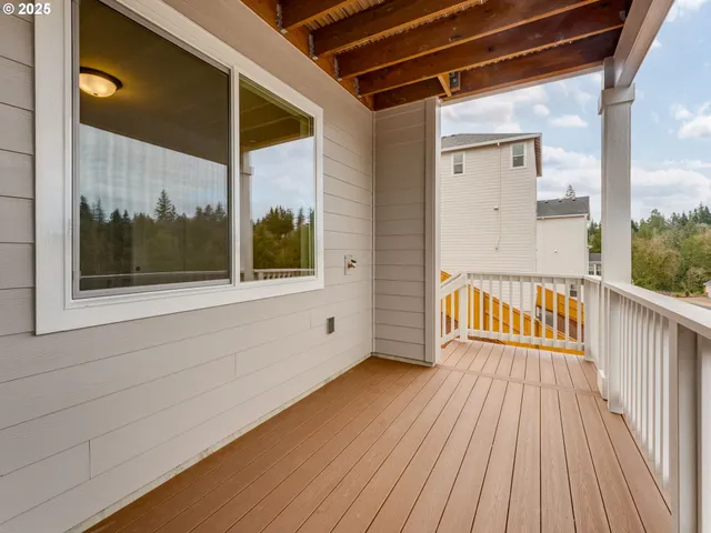 a view of a balcony with wooden floor
