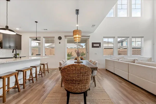 a room with counter top space a chandelier and wooden floor