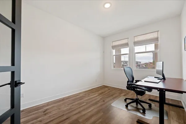 a view of a workspace with wooden floor