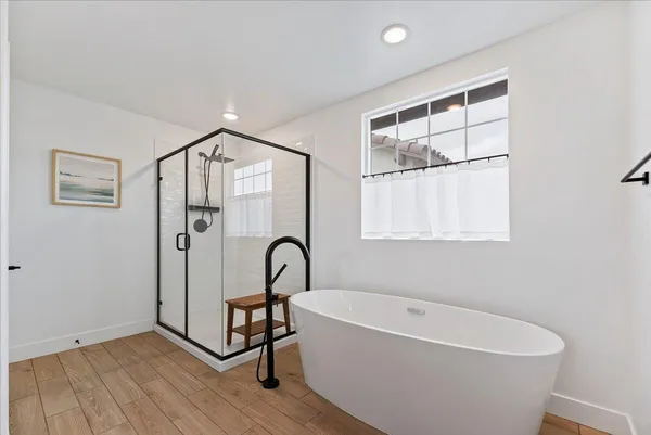 a bathroom with a bathtub and a shower