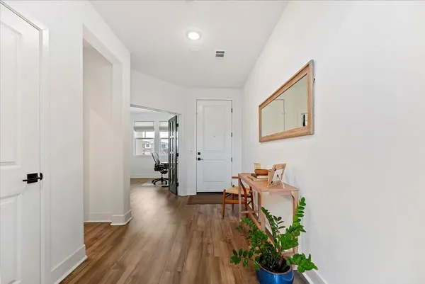 a hallway with table and flowerpot
