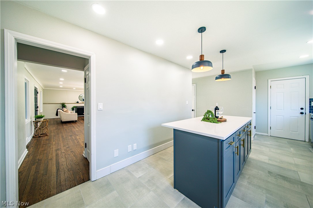 Kitchen featuring a kitchen island, hanging light fixtures, and light hardwood / wood-style floors