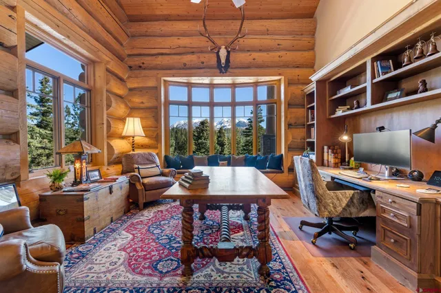 a living room with furniture a rug and a large window