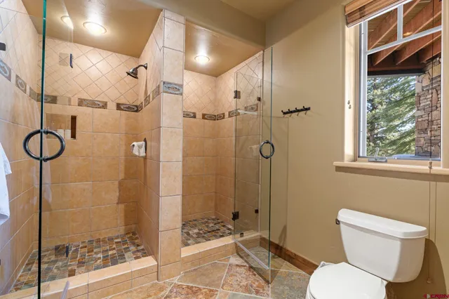 a bathroom with a toilet and shower