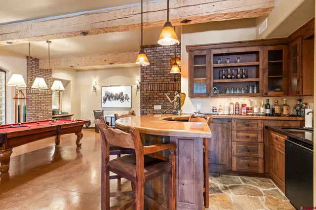 a kitchen with a table chairs and white cabinets