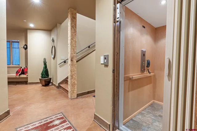 a view of hallway with stairs and wooden floor