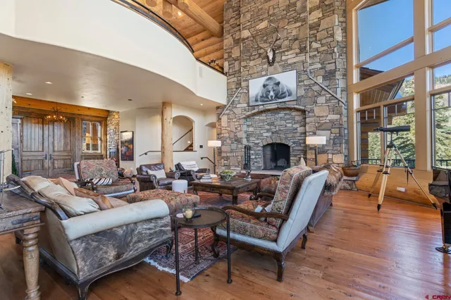 a living room with furniture fireplace and wooden floor