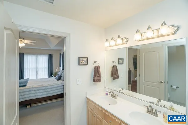 a bedroom with furniture and a chandelier