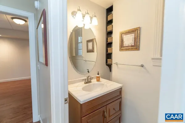 a view of a big house with a small yard and large tree