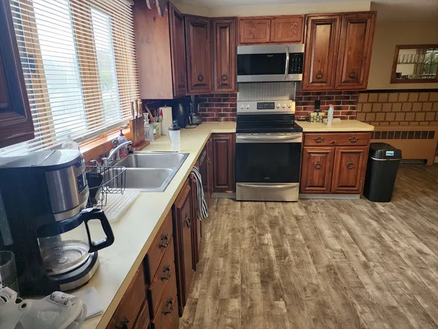 a kitchen with a stove sink and a microwave