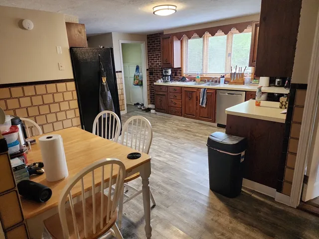 a table and chairs in a room next to a window