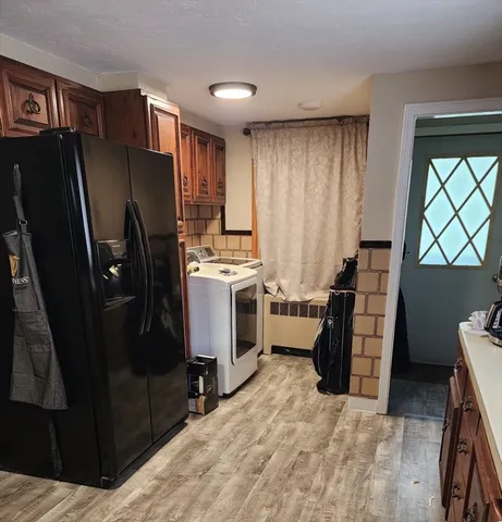 a view of a kitchen with fridge and workspace