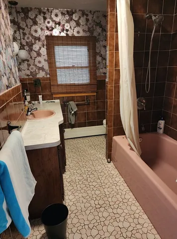 a bathroom with a sink a toilet and bathtub