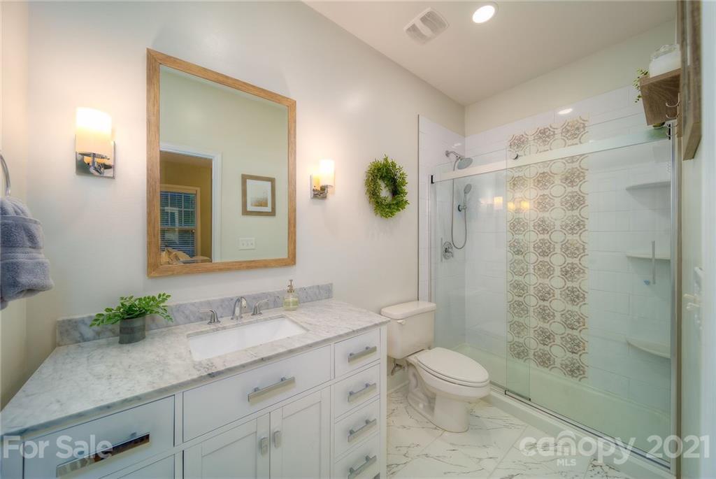 4142 Walker Road Charlotte, NC 28211 - Photo 11 of 18 a bathroom with a granite countertop sink a toilet and shower