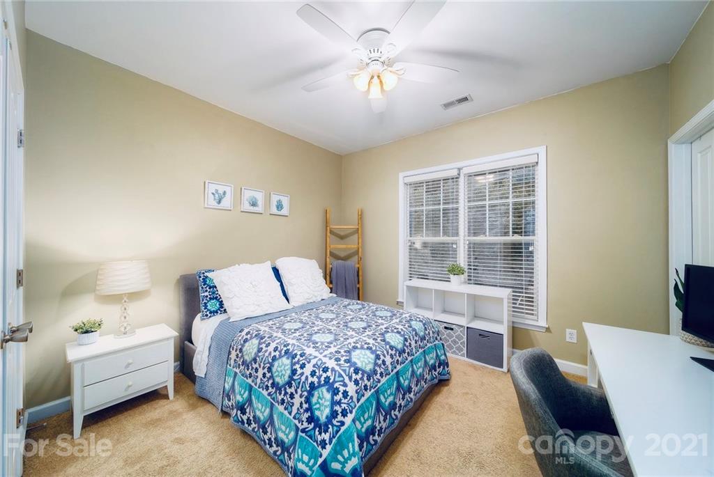 4142 Walker Road Charlotte, NC 28211 - Photo 13 of 18 a bedroom with a bed and a couch
