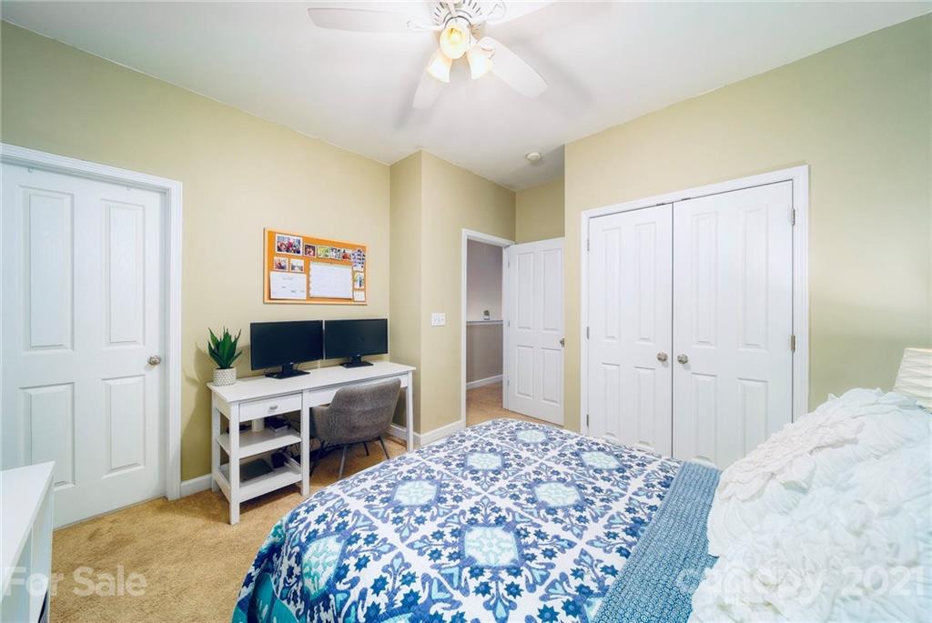 4142 Walker Road Charlotte, NC 28211 - Photo 14 of 18 a bedroom with a bed and a desk in it
