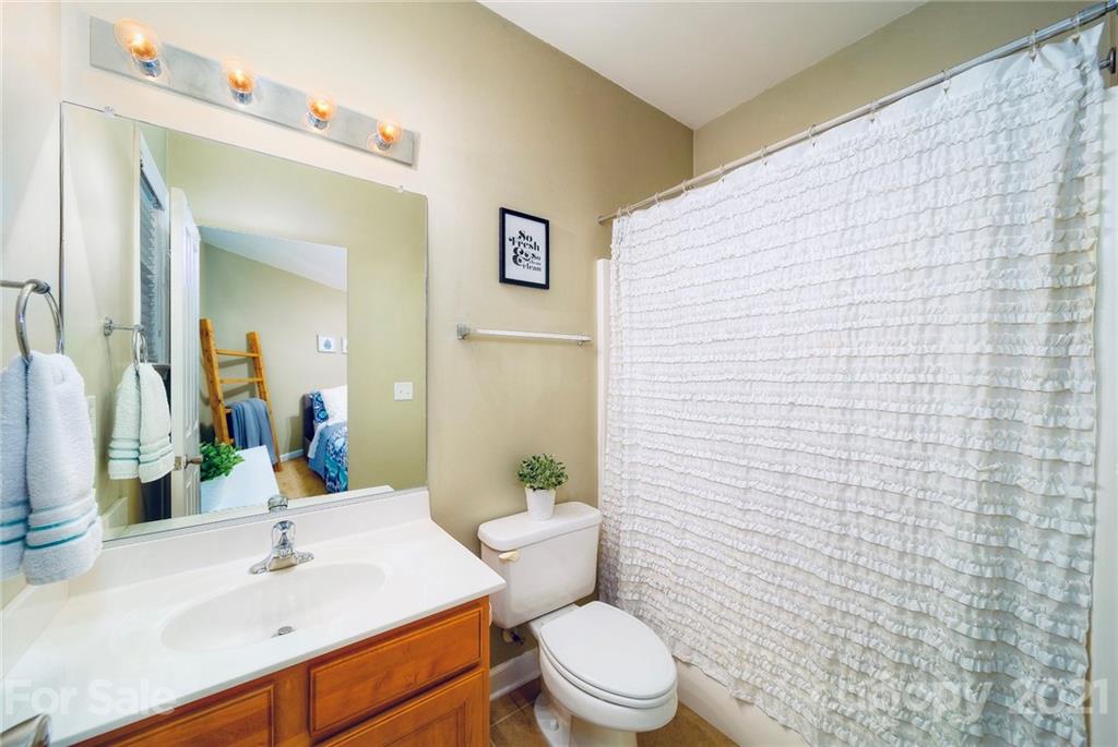 4142 Walker Road Charlotte, NC 28211 - Photo 15 of 18 a bathroom with a sink a toilet and shower