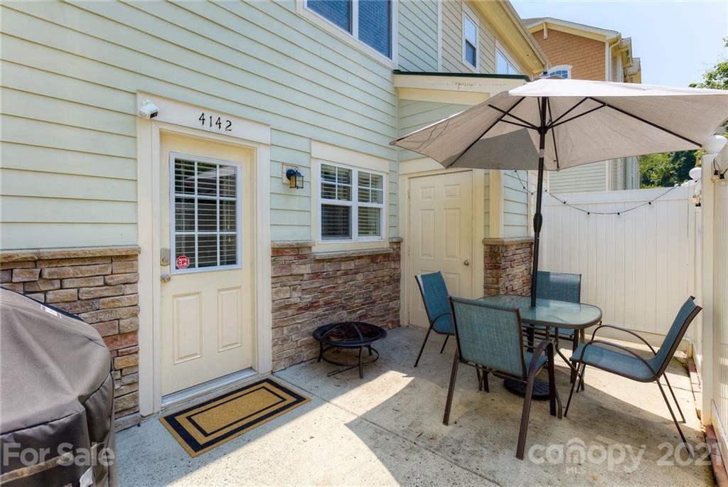 4142 Walker Road Charlotte, NC 28211 - Photo 6 of 18 a balcony with table and chairs
