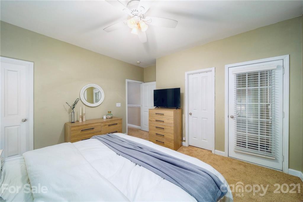 4142 Walker Road Charlotte, NC 28211 - Photo 9 of 18 a bedroom with a bed and a flat tv screen on dresser