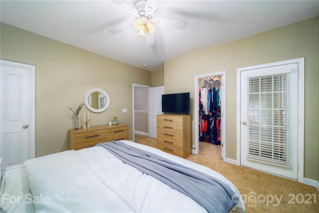 4142 Walker Road Charlotte, NC 28211 - Photo 10 of 18 a bedroom with a bed and a flat screen tv