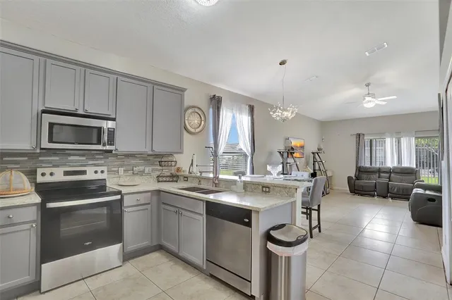 a kitchen with a sink stove and microwave
