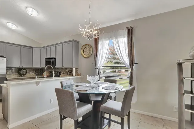 a kitchen with a dining table and chairs