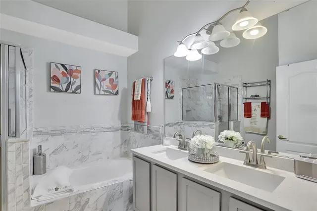 a bathroom with a sink a bathtub and a mirror