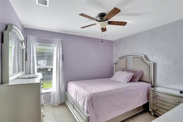 a bedroom with a large bed and a window