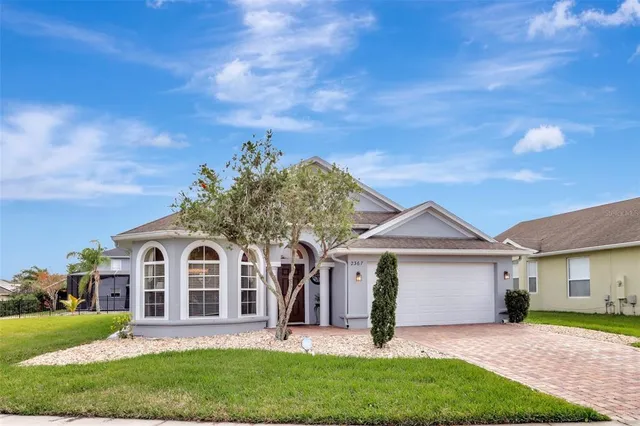 a front view of a house with a garden and yard