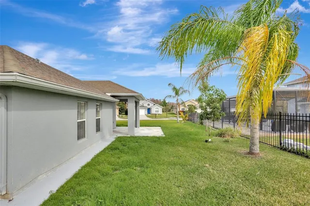 a backyard of a house with lots of green space