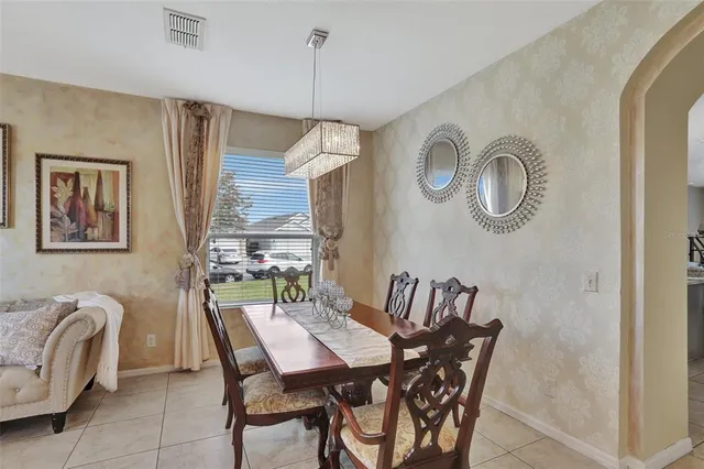 a view of a dining room with furniture and a chandelier