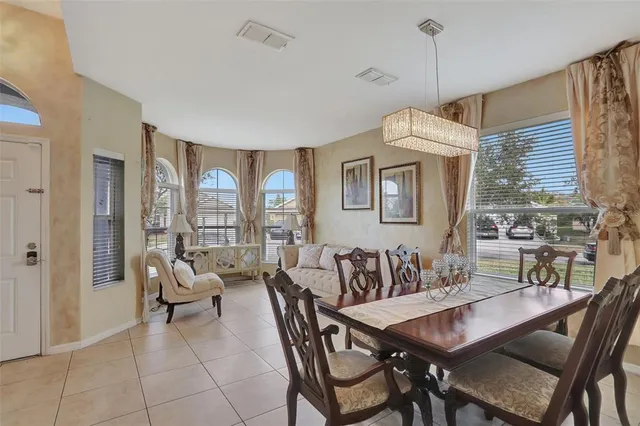 a dining room with furniture a chandelier and window